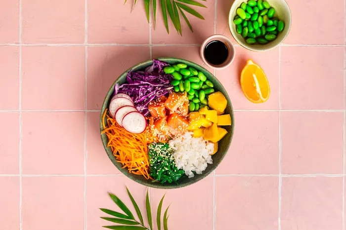 Bol saludable con verduras, salmón y semillas visto desde arriba